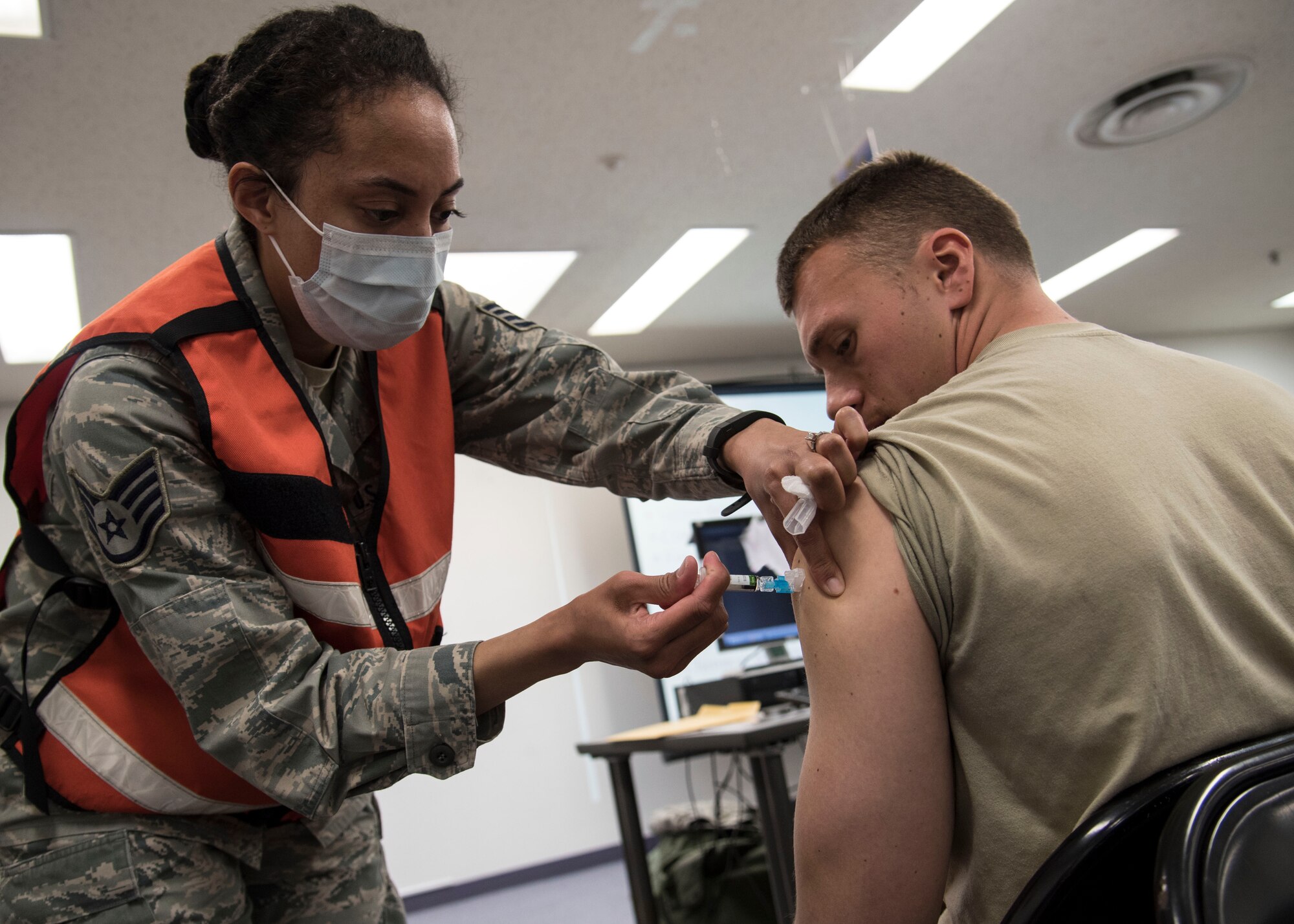 U.S. Air Force Staff Sgt. Cherie Gregory, the allergy immunizations NCO in charge with the 35th Medical Operations Squadron, administers a vaccine at Misawa Air Base, Japan, March 15, 2016. While taking part in Beverly Sunrise 16-03, an operational readiness exercise, Airmen attended a mock Personnel Deployment Function ensuring their medical records were up-to-date. Personnel who were due for vaccinations were received them before the mock departure. (U.S. Air Force photo by Airman 1st Class Jordyn Fetter)