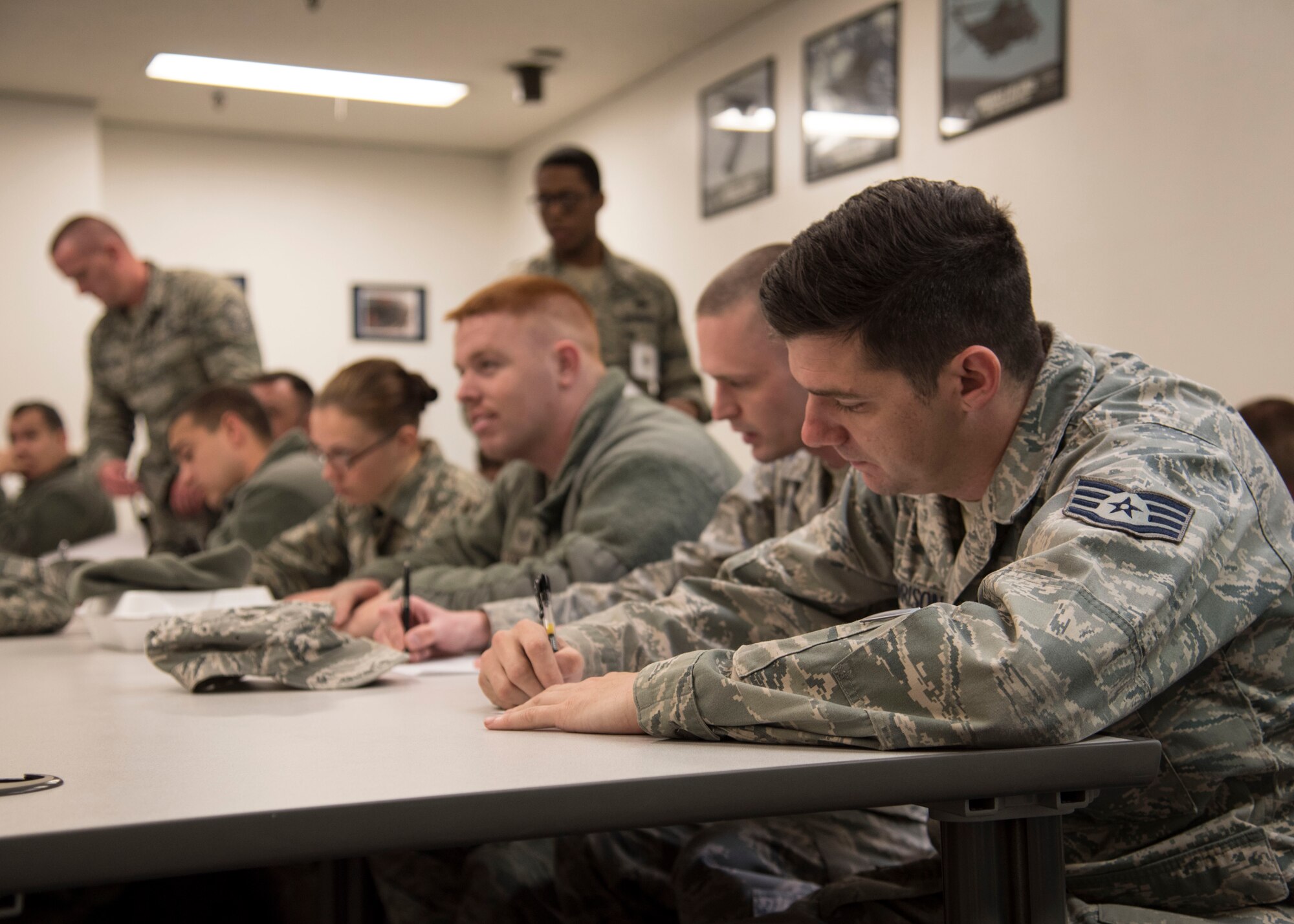 U.S. Air Force Airmen fill out deployment documents at Misawa Air Base, Japan, March 15, 2016. Upon the start of Beverly Sunrise 16-03, an operational readiness exercise, Airmen prepared for the mock deployment through a Personnel Deployment Function. This process ensured personnel possess all necessary paperwork and equipment, as well as confirming their medical records are up-to-date. (U.S. Air Force photo by Airman 1st Class Jordyn Fetter)