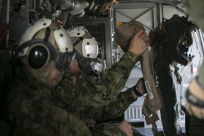 Japan Ground Self-Defense Force service members prepare for a flight on an MV-22B Osprey by putting on cranials to protect their head and ears, as well as an inflatable vest in case of emergency over a body of water, during their visit to Marine Corps Air Station Futenma, Okinawa, Japan, March 8, 2016. U.S. Marine crew chiefs give safety briefs to their passengers before each flight, explaining emergency exits, evacuation steps. The Japanese service members visited MCAS Futenma to strengthen relations in the Asia-Pacific and to view the capabilities of the Osprey firsthand. The Osprey is with Marine Medium Tiltrotor Squadron 262, Marine Aircraft Group 36, 1st Marine Aircraft Wing, III Marine Expeditionary Force.