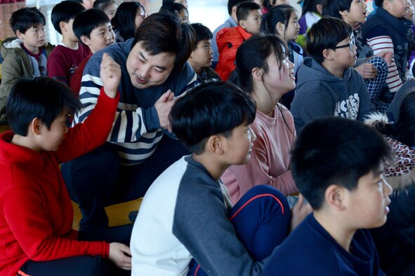 Children from Okbong Elementary school listen as the U.S. Air Force Band of the Pacific-Asia Pacific Trends ensemble perform during a visit in Gunsan City, Republic of Korea, Mar. 15, 2016. The 6-person team performed popular songs from artists such as Bruno Mars and Adele for 145 children and staff. (U.S. Air Force photo by Senior Airman Ashley L. Gardner/Released) 