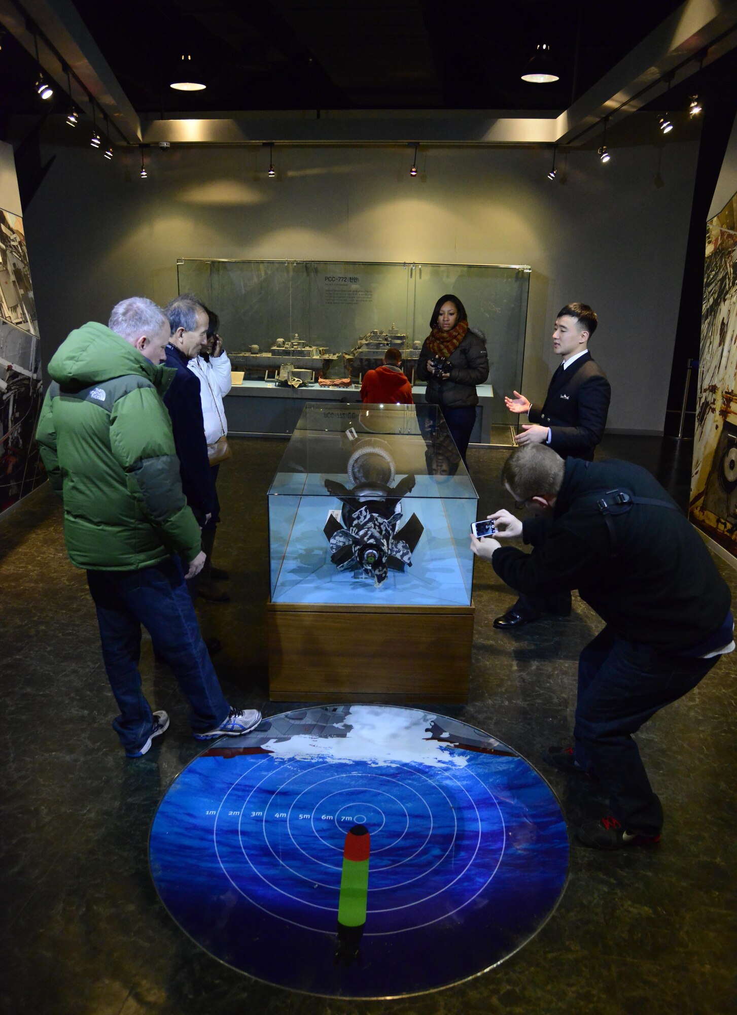 Republic of Korea Navy Petty Officer 1st Class Jung, Samuel, shows 51st Fighter Wing public affairs members the North Korean torpedo that sunk the ROK Navy vessel Cheonan while touring the West Sea Protection Hall at the ROK Navy 2nd Fleet Command in Pyeongtaek-si, Gyeonggi-do Province on Feb. 26, 2016. The attack occurred at 9:22 p.m. on March 26, 2010, killing 46 ROK Sailors. It’s one of many recent attacks on South Korea from North Korea patrols. (U.S. Air Force photo by Senior Airman Kristin High/Released)