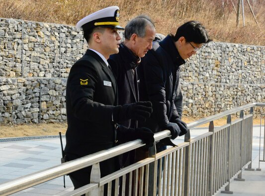 Republic of Korea Navy Petty Officer 1st Class Jung, Samuel speaks with Yi, Chong Kun and Pak, Yong Hui, 51st Fighter Wing public affairs community relations liaisons, about the Yeonpyeong Sea Battles and the attack on ROK Navy ship Cheonan at the ROK Navy 2nd Fleet Command in Pyeongtaek-si, Gyeonggi-do Province on Feb. 26, 2016. The incidents are some of the recent attacks Republic of Korea from North Korea patrols. (U.S. Air Force photo by Senior Airman Kristin High/Released)
