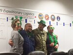 DLA Distributions Organizational Management and Expeditionary Directorate employees Danielle Oehm, Bradford Sims, Army Col Ronnie Davis and Rick Barber, celebrate St. Patrick’s Day with a chili cook-off on Mar. 14.