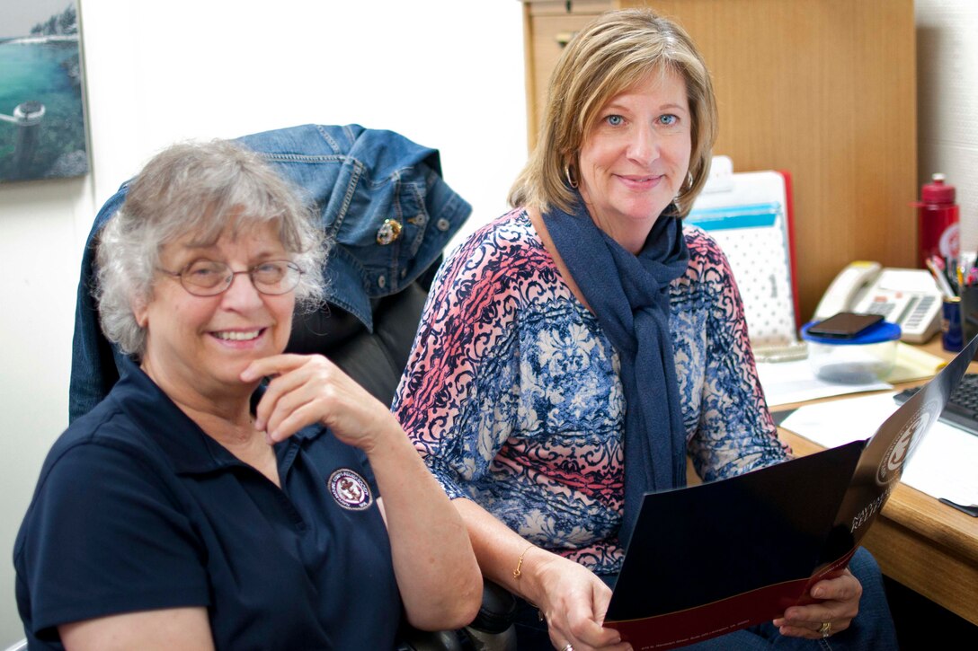 Presha Ann Merritt, Navy-Marine Corps Relief Society regional director, and Carey Schott, chair of volunteers, prepare for the annual active duty fund drive in support of the Navy-Marine Corps Relief Society aboard Marine Corps Base Quantico.  Both Merritt and Schott are passionate members of the Quantico branch: Merritt serving for 21 years and Schott serving nearly 5,000 volunteer hours. 