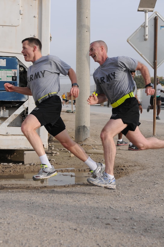 U.S. Army Lt. Gen. Jeffrey Talley, left, the chief of the Army Reserve, and Command Sgt. Maj. James Lambert, his senior enlisted advisor, race to the finish line of a 5K run to mark the component's 105th anniversary at Kandahar Airfield in Kandahar province, Afghanistan, April 27, 2013. (U.S. Army photo by Sgt. Phillip Valentine/Released)