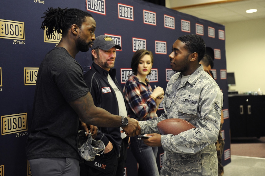 Pro football player Charles Tillman, left, exchanges greetings with Air Force Senior Airman Justin Credit during the USO spring entertainment visit on Kadena Air Base, Japan, March 14, 2016. Credit is a bioenvironmental engineering technician assigned to the 18th Aerospace Medicine Squadron. Air Force photo by Senior Airman Peter Reft