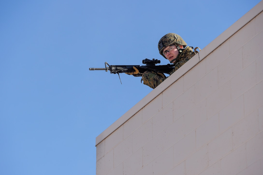 A Marine provides security while members of his team clear a complex during urban operations training on Joint Base Elmendorf-Richardson, Alaska, March 6, 2016. Air Force photo by Alejandro Pena