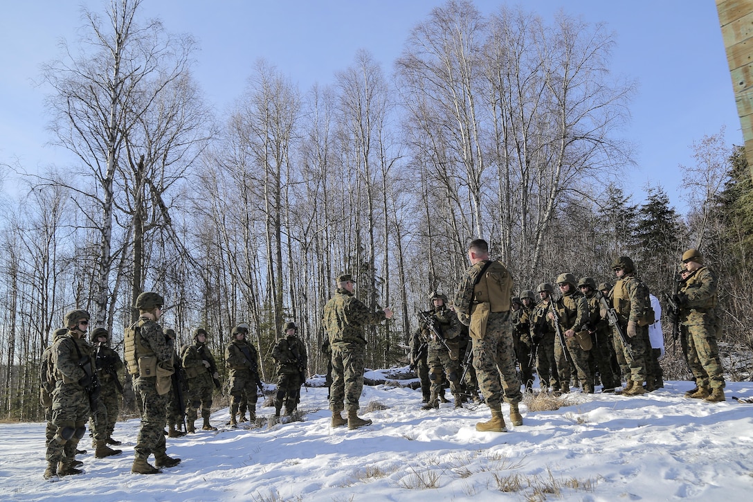 Marine Corps Capt. Sean Smith-Kearon, center, briefs his Marines during a pause in urban operations training on Joint Base Elmendorf-Richardson, Alaska, March 6, 2016. Smith-Kearon is executive officer for Detachment Military Police, Delta Company, 4th Law Enforcement Battalion. Air Force photo by Alejandro Pena