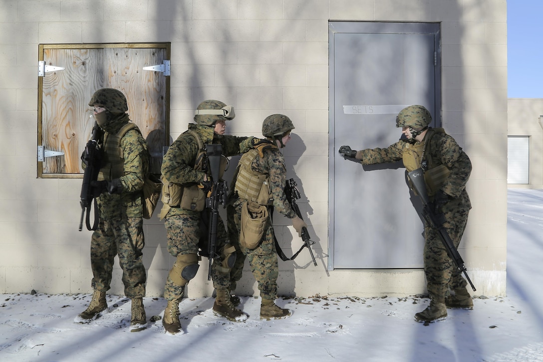 Marines prepare to enter a building during urban operations training on Joint Base Elmendorf-Richardson, Alaska, March 6, 2016. Air Force photo by Alejandro Pena
