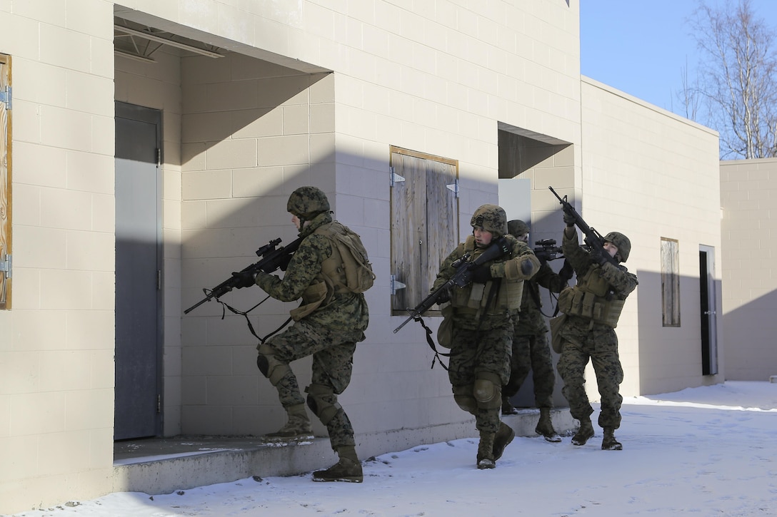 Marines assault and clear a complex during urban operations training on Joint Base Elmendorf-Richardson, Alaska, March 6, 2016. Air Force photo by Alejandro Pena