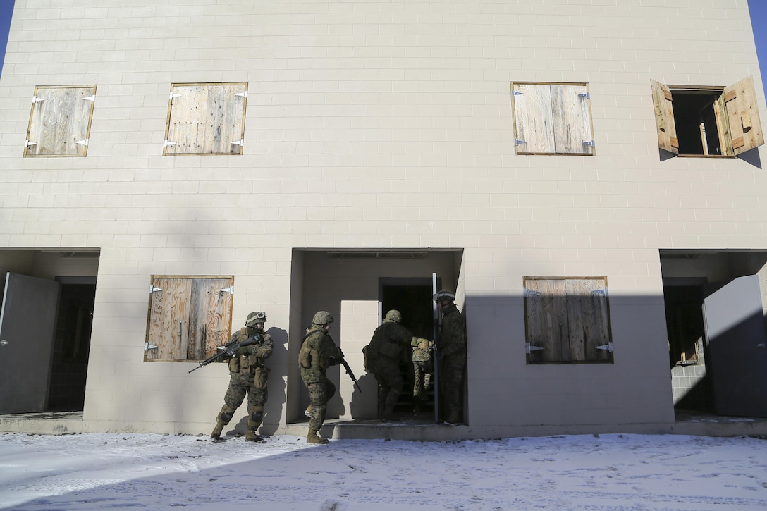 Marines assault and clear a complex during urban operations training on Joint Base Elmendorf-Richardson, Alaska, March 6, 2016. Air Force photo by Alejandro Pena