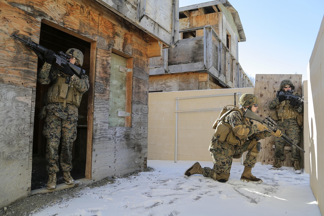 Marines provide security after clearing a building during urban operations training on Joint Base Elmendorf-Richardson, Alaska, March 6, 2016. Air Force photo by Alejandro Pena