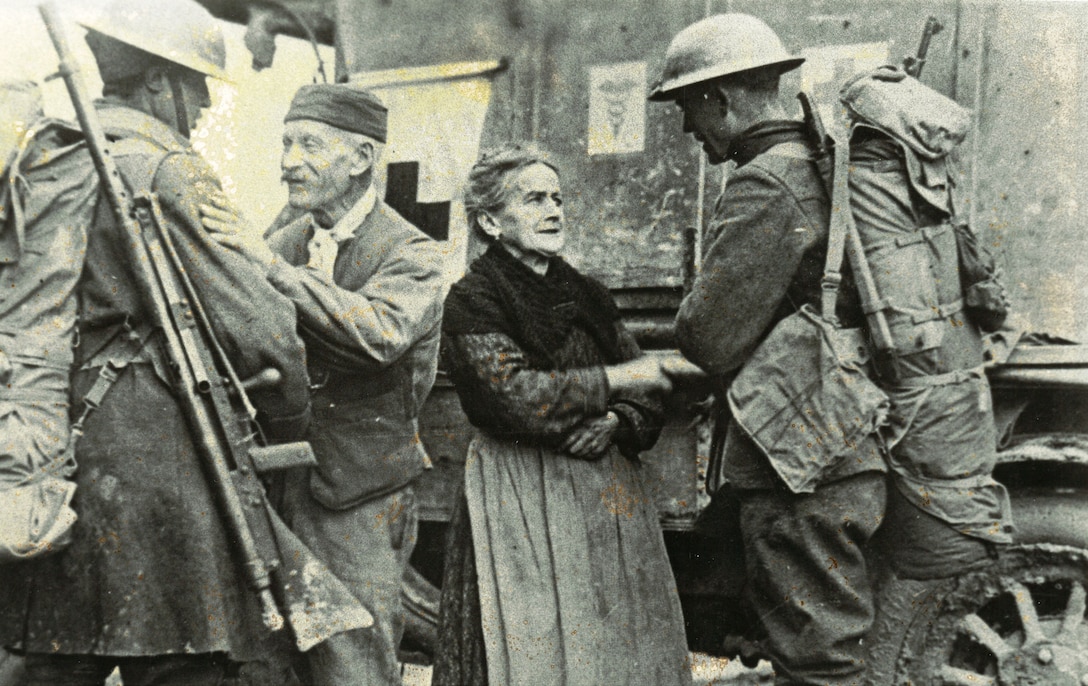 Soldiers from the 308th Infantry Regiment (part of the 77th Inf. Div.) and 166th Infantry Regiment (part of the 42nd Inf. Div. {the Rainbow Division}) as "...they liberate a French town in 1918..."