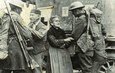 Soldiers from the 308th Infantry Regiment (part of the 77th Inf. Div.) and 166th Infantry Regiment (part of the 42nd Inf. Div. {the Rainbow Division}) as "...they liberate a French town in 1918..."