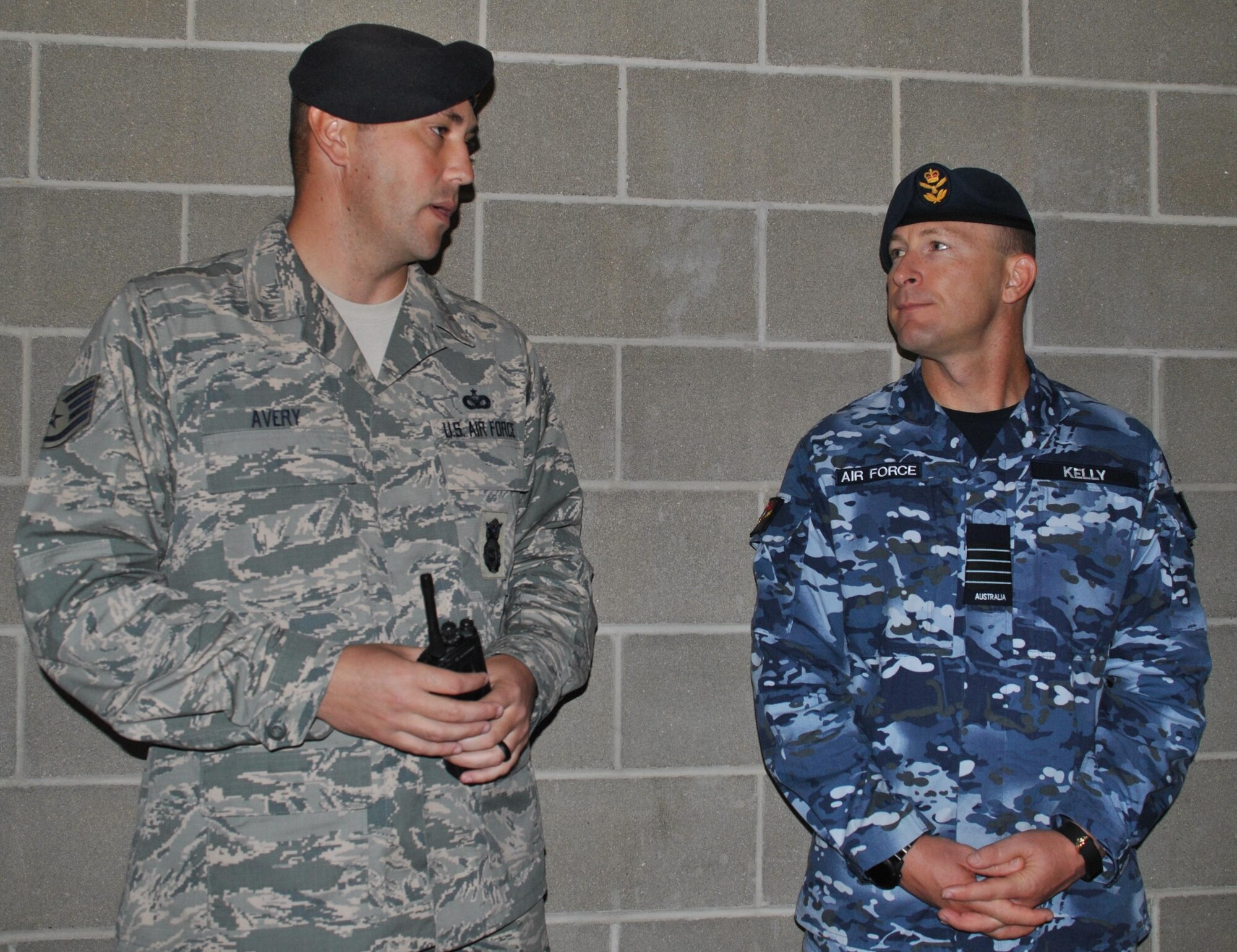 U.S. Air Force Staff Sgt. Kevin Avery briefs Royal Australian Air Force Group Capt. Wayne Kelly during a domestics training exercise at Lackland Medina Training Annex. During the demonstration, Avery explained how to defuse a domestic violence situation involving Airmen living on base. (U.S. Air Force photo/Carole Chiles Fuller/Released)  
