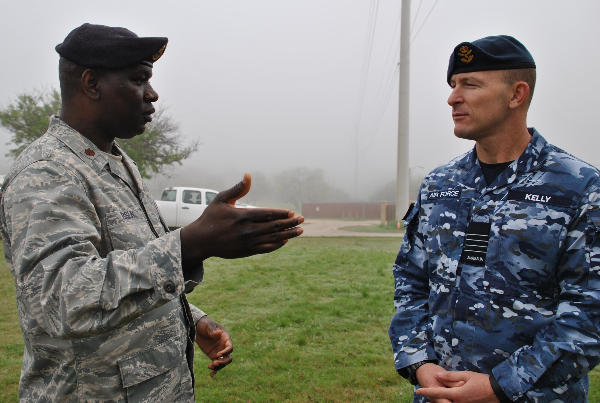 U.S. Air Force Maj. Schneider Rislin, director of operations for the 341st Training Squadron, briefs Royal Australian Air Force Group Capt. Wayne Kelly during a detection demonstration involving military working dogs. While the USAF uses MWDs for detection and patrol, Kelly said the RAAF uses one MWD apiece for both duties. (U.S. Air Force photo/Carole Chiles Fuller/Released)