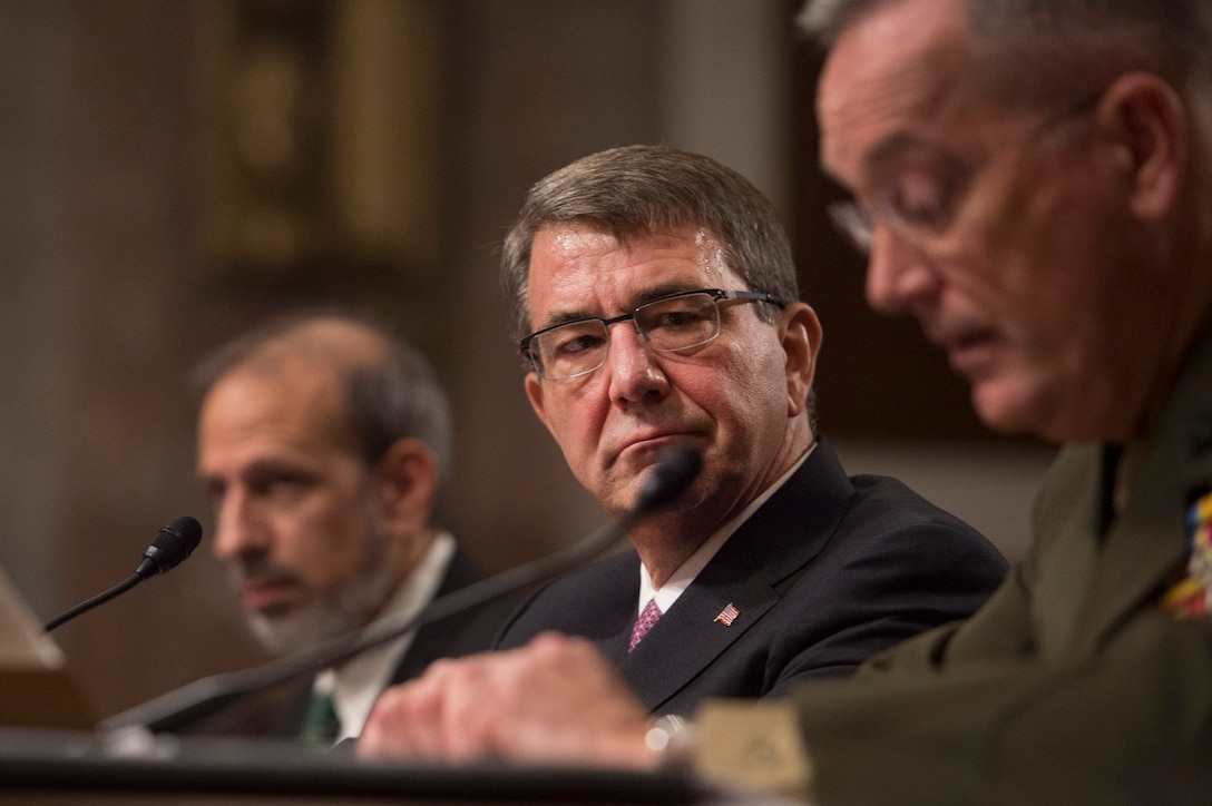 Defense Secretary Ash Carter listens as Marine Corps Gen. Joseph Dunford, chairman of the Joint Chiefs of Staff, testifies on the Defense Department's proposed fiscal year 2017 budget before the Senate Armed Services Committee in Washington, D.C., March 17, 2016. DoD photo by Senior Master Sgt. Adrian Cadiz