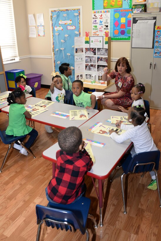 Martha Cook, HNC executive officer, speaks to Ms. Maze's pre-kindergarten students about their project during the First Baptist Child Development Center & Academy science fair.