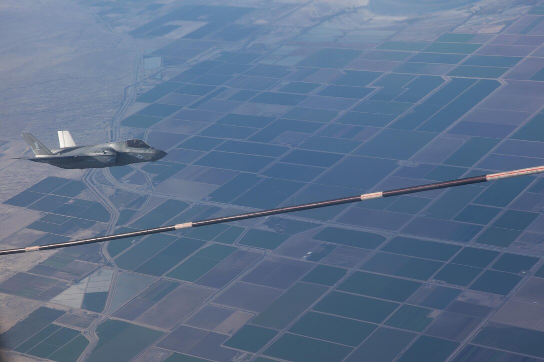 An F-35B Lightning II with Marine Fighter Attack Squadron (VMFA) 121 “Green Knights” flies alongside a KC-130J Super Hercules with Marine Aerial Refueler Transport Squadron (VMGR) 352 over Southern California, March 8. Marines with VMGR-352 supported an aerial refueling mission with two F-35Bs from VMFA-121. (U.S. Marine Corps photo by Sgt. Lillian Stephens/Released)