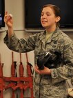 Airman 1st Class Victoria Hammond, 2nd Civil Engineer Squadron emergency manager, shows Airmen a self-sealing disk valve during chemical, biological, radiological and nuclear defense survival skills training at Barksdale Air Force Base, La., March 8, 2016. Hammond taught the Airmen how to inspect different pieces of equipment for tears, slits and degradation. (U.S. Air Force photo/Senior Airman Amanda Morris)