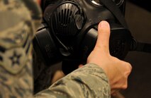 An Airman attaches a filter to an M50 gas mask during chemical, biological, radiological and nuclear defense survival skills training at Barksdale Air Force Base, La., March 8, 2016. Airmen that attended the course learned how to properly care for and use their equipment and how to respond in the event of a CBRN attack. (U.S. Air Force photo/Senior Airman Amanda Morris)