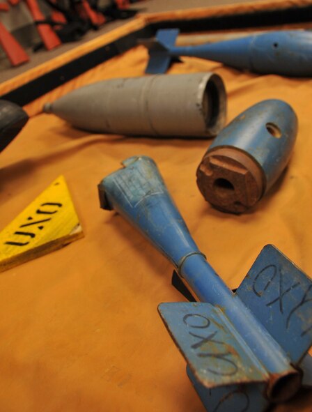 Unexploded ordnance training aids sit on display during chemical, biological, radiological and nuclear defense survival skills training at Barksdale Air Force Base, La., March 8, 2016. The visual aids are used to teach Airmen how respond during a CBRN attack. (U.S. Air Force photo/Senior Airman Amanda Morris)