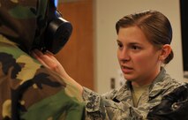 Airman 1st Class Victoria Hammond, 2nd Civil Engineer Squadron emergency manager, inspects an Airman’s equipment to ensure he is wearing it properly during chemical, biological, radiological and nuclear defense survival skills training at Barksdale Air Force Base, La., March 8, 2016. During training Airmen had to demonstrate how to prepare for different mission-oriented protective postures. (U.S. Air Force photo/Senior Airman Amanda Morris)