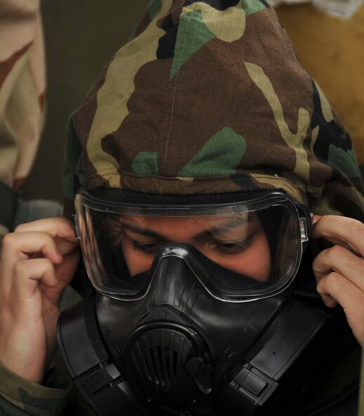 An Airman dons protective equipment during chemical, biological, radiological and nuclear defense survival skills training at Barksdale Air Force Base, La., March 8, 2016. During training, Airmen were taught how to properly care for and wear protective equipment. Failure to properly care for and inspect protective gear can lead to illness or death in the event of a CBRN attack. (U.S. Air Force photo/Senior Airman Amanda Morris)