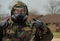 An Airman signals the evaluator that his team as finished a training scenario during chemical, biological, radiological and nuclear defense survival skills training at Barksdale Air Force Base, La., March 8, 2016. During training, Airmen learned how to properly care for protective equipment, prepare for different mission-oriented protective postures, identify unexploded ordnances, avoid contamination and respond in the event of a CBRN attack. (U.S. Air Force photo/Senior Airman Amanda Morris) 