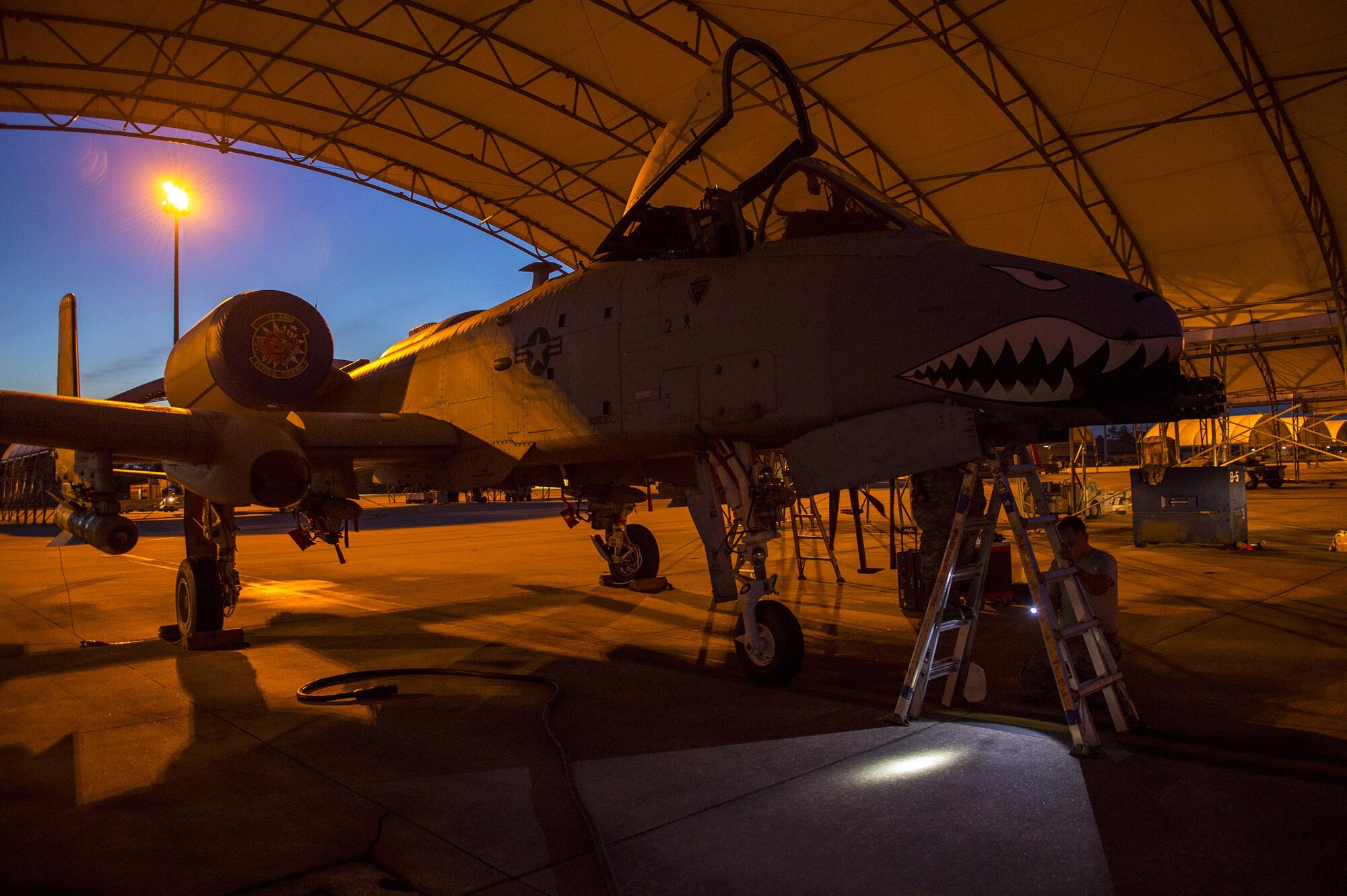 An A-10C Thunderbolt II rests under an awning while U.S. Air Force Airmen from the 74th Aircraft Maintenance Unit perform repairs, March 10, 2016, at Moody Air Force Base, Ga. A-10’s are primarily used for close air support due to their weapons-delivery systems and their ability to maneuver at low air speeds and altitude. (U.S. Air Force photo by Airman 1st Class Lauren M. Johnson/Released)