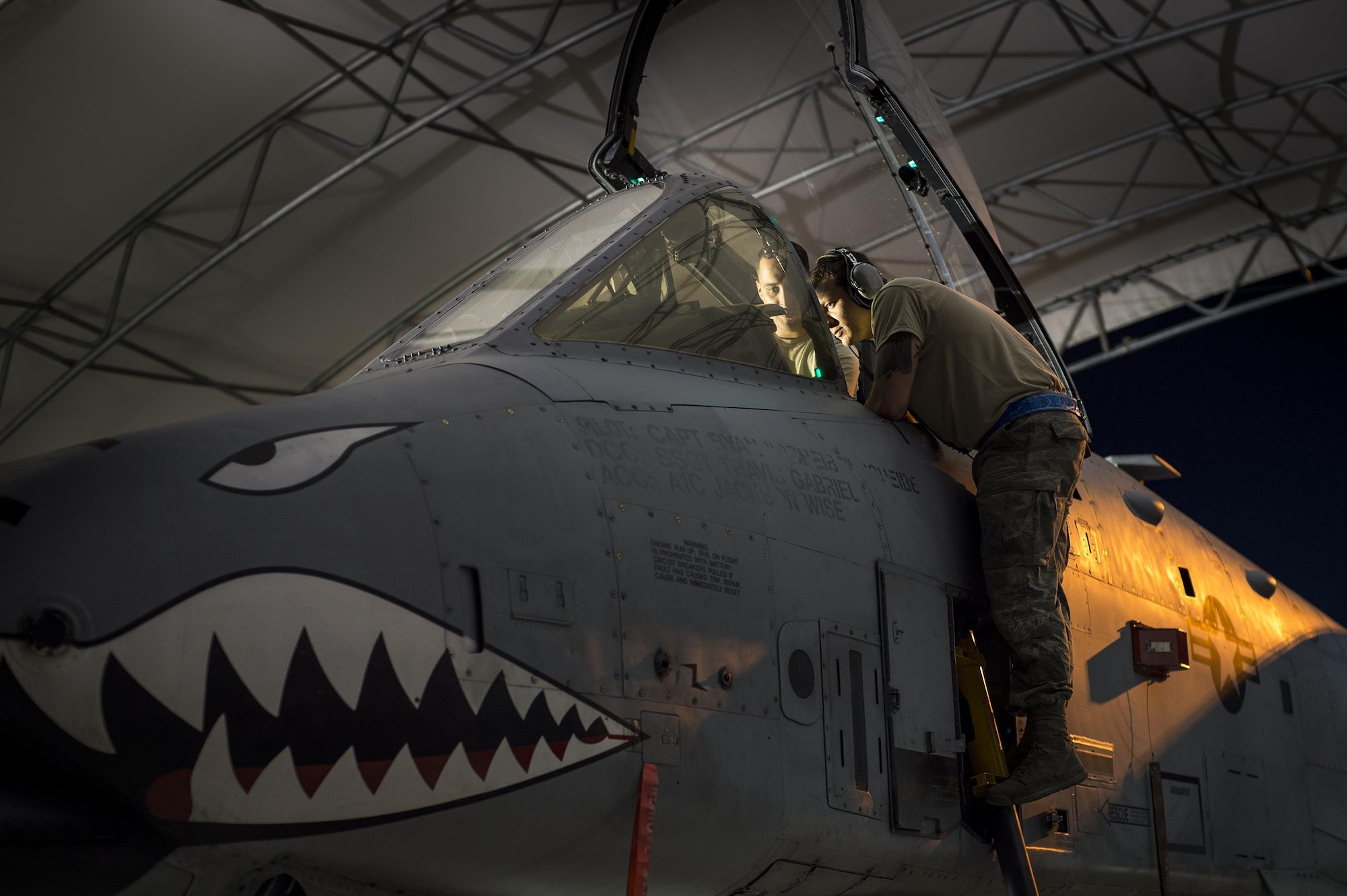U.S. Air Force Senior Airman Jonathan Buzhardt, 74th Aircraft Maintenance Unit electrical and environmental systems journeyman, assists Staff Sgt. Matthew Hebert, 74th AMU avionics specialist technician, with the repair of a display in an A-10C Thunderbolt II, March 10, 2016, at Moody Air Force Base, Ga. The 74th AMU swing shift maintainers repair broken aircraft and perform routine servicing each night in order to maintain mission capability. (U.S. Air Force photo by Airman 1st Class Lauren M. Johnson/Released)