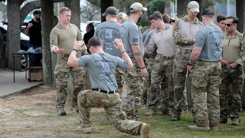 Marine Staff Sgt. Nathan Harris, who organized the ruck, stretches out to prepare for his 110-mile journey during a 770-mile ruck from Navarre, Florida, to Marine Corps Base Camp Lejeune, North Carolina to honor 11 service members who died in a helicopter crash one year ago. For the next 10 days, the ruckers will walk in seven teams and trade off every 10-11 miles, about 110 miles each, until they get there.