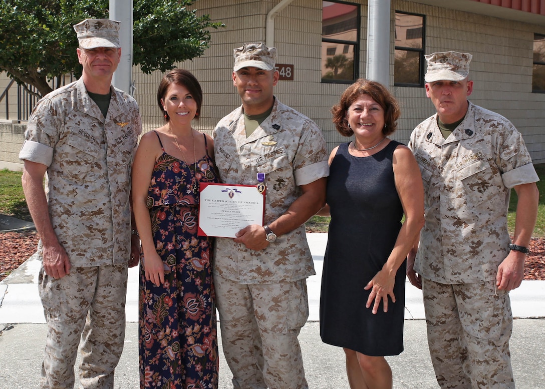 TAMPA, Fla. – Master Sgt. Adrian M. Marquez Ayala is presented the Purple Heart medal by Lieutenant. Gen. William D. Beydler Mar. 17, 2016, at a ceremony MacDill Air Force Base, Fla. Marquez received the Purple Heart for injuries he sustained on 8 November 2004, during Operation PHANTOM FURY in Fallujah, Iraq. Marquez is currently assigned to Wounded Warrior Battalion, Tampa Detachment. Beydler is the Commanding General of Marine Corps Forces Central Command.