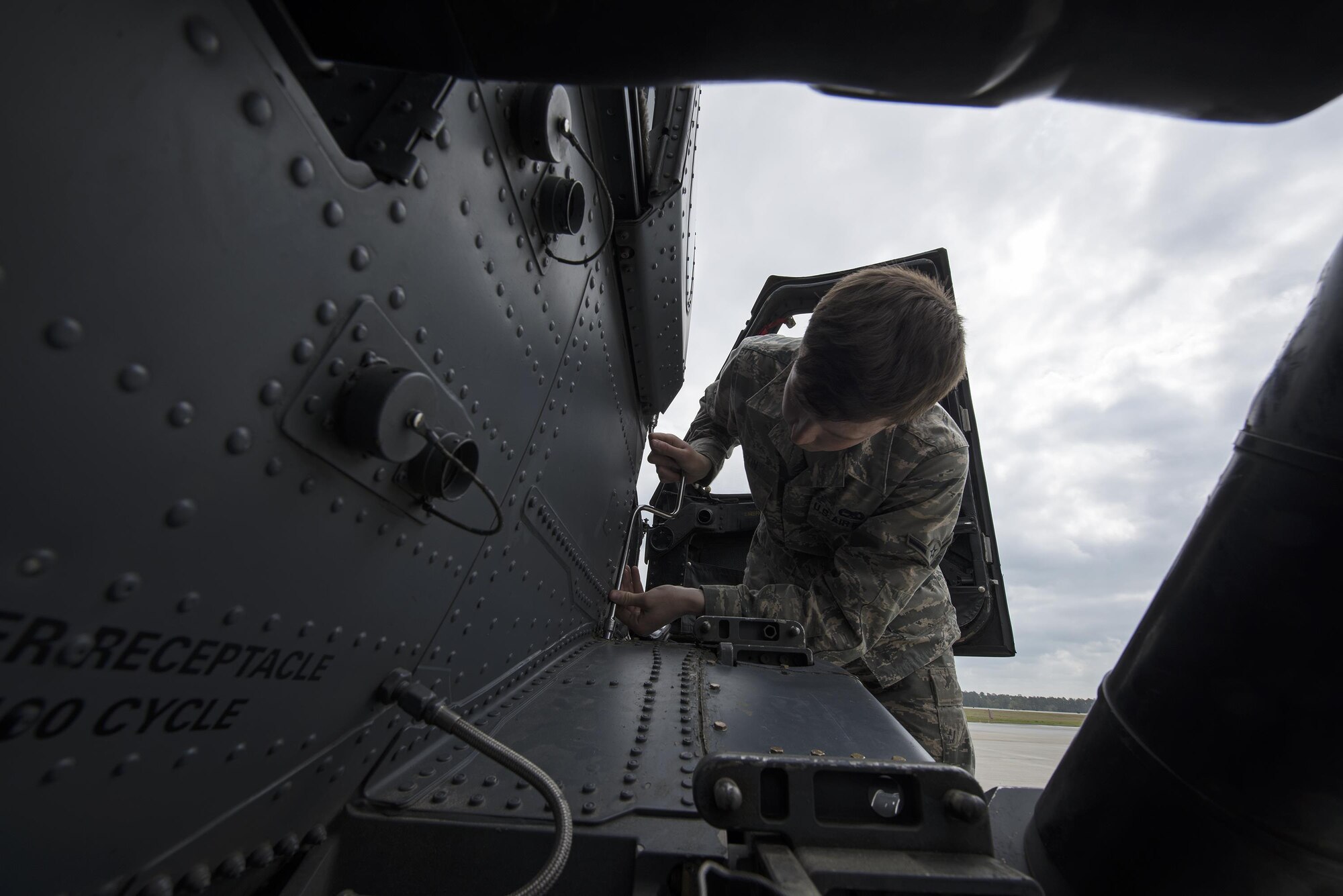 U.S. Air Force Airman Gabriel Martin, 41st Helicopter Maintenance Unit crew chief apprentice, secures a support fairing to an HH-60G Pave Hawk helicopter during routine maintenance, March 16, 2016, at Moody Air Force Base, Ga. The 41st HMU is responsible for 13 Pave Hawks and must keep them all mission ready in case of a real-world emergency. (U.S. Air Force Photo by Airman 1st Class Janiqua P. Robinson/Released)
