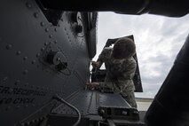 U.S. Air Force Airman Gabriel Martin, 41st Helicopter Maintenance Unit crew chief apprentice, secures a support fairing to an HH-60G Pave Hawk helicopter during routine maintenance, March 16, 2016, at Moody Air Force Base, Ga. The 41st HMU is responsible for 13 Pave Hawks and must keep them all mission ready in case of a real-world emergency. (U.S. Air Force Photo by Airman 1st Class Janiqua P. Robinson/Released)
