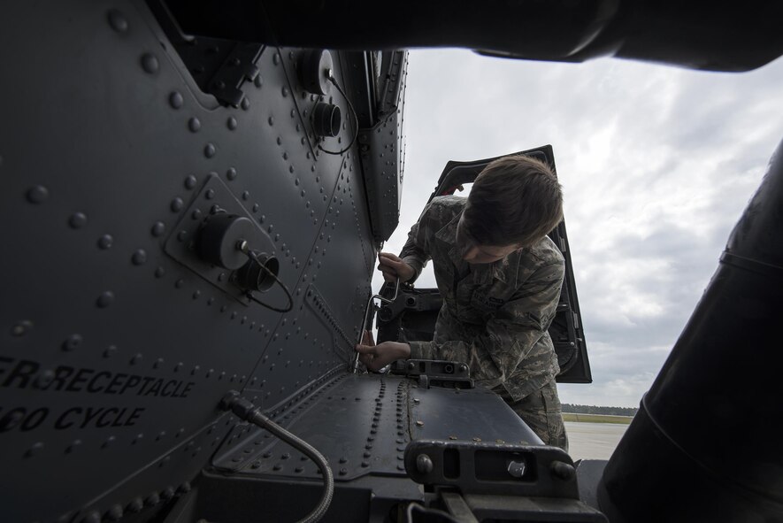 U.S. Air Force Airman Gabriel Martin, 41st Helicopter Maintenance Unit crew chief apprentice, secures a support fairing to an HH-60G Pave Hawk helicopter during routine maintenance, March 16, 2016, at Moody Air Force Base, Ga. The 41st HMU is responsible for 13 Pave Hawks and must keep them all mission ready in case of a real-world emergency. (U.S. Air Force Photo by Airman 1st Class Janiqua P. Robinson/Released)

