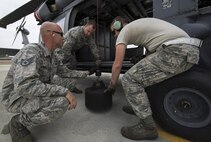 U.S. Air Force Airmen from the 41st Helicopter Maintenance Unit test a rescue hoist on an HH-60G Pave Hawk helicopter after routine maintenance, March 16, 2016, at Moody Air Force Base, Ga. The hoist, containing 200 feet of cable, is used during combat search and rescue missions to recover isolated personnel and can safely hold 600 pounds. (U.S. Air Force Photo by Airman 1st Class Janiqua P. Robinson/Released)