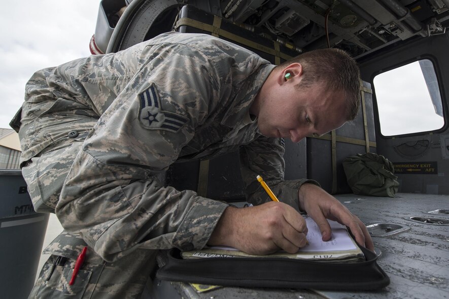 U.S. Air Force Senior Airman John Dwinell, 41st Helicopter Maintenance Unit crew chief journeyman, annotates the maintenance performed on an HH-60G Pave Hawk helicopter, March 16, 2016, at Moody Air Force Base, Ga. Airmen assigned to the 41st HMU must keep track of all maintenance performed on the HH-60Gs to ensure mission readiness. (U.S. Air Force Photo by Airman 1st Class Janiqua P. Robinson/Released)