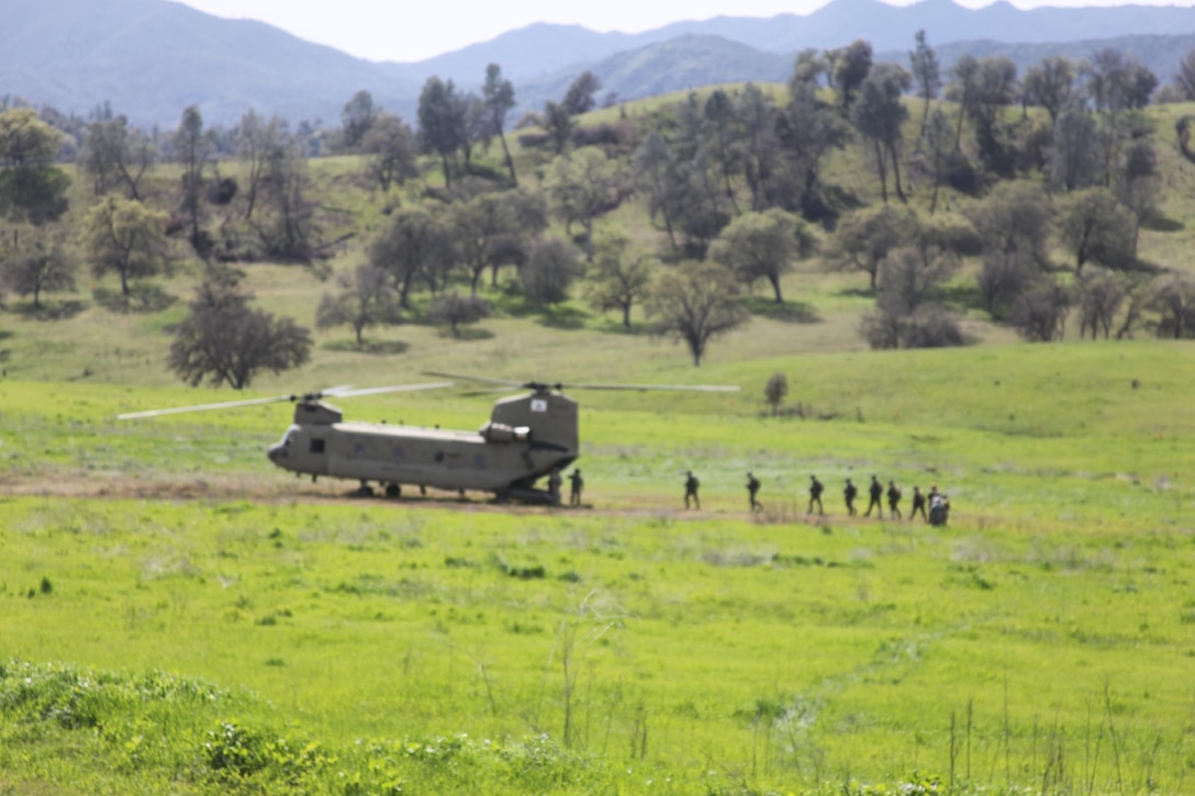 Marines of 4th Force Reconnaissance Company, 4th Marine Division, Marine Forces Reserve, load a CH-47 helicopter manned by Bravo Company, 1st Battalion, 126th Aviation Regiment, California Army National Guard at Fort Hunter Liggett, Calif. The Marines spent five days improving their reconnaissance mission techniques, March 8-12, 2016. (Photo courtesy of 4th Force Recon)