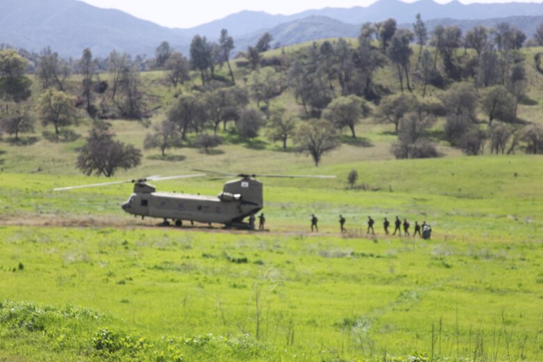 Marines of 4th Force Reconnaissance Company, 4th Marine Division, Marine Forces Reserve, load a CH-47 helicopter manned by Bravo Company, 1st Battalion, 126th Aviation Regiment, California Army National Guard at Fort Hunter Liggett, Calif. The Marines spent five days improving their reconnaissance mission techniques, March 8-12, 2016. (Photo courtesy of 4th Force Recon)