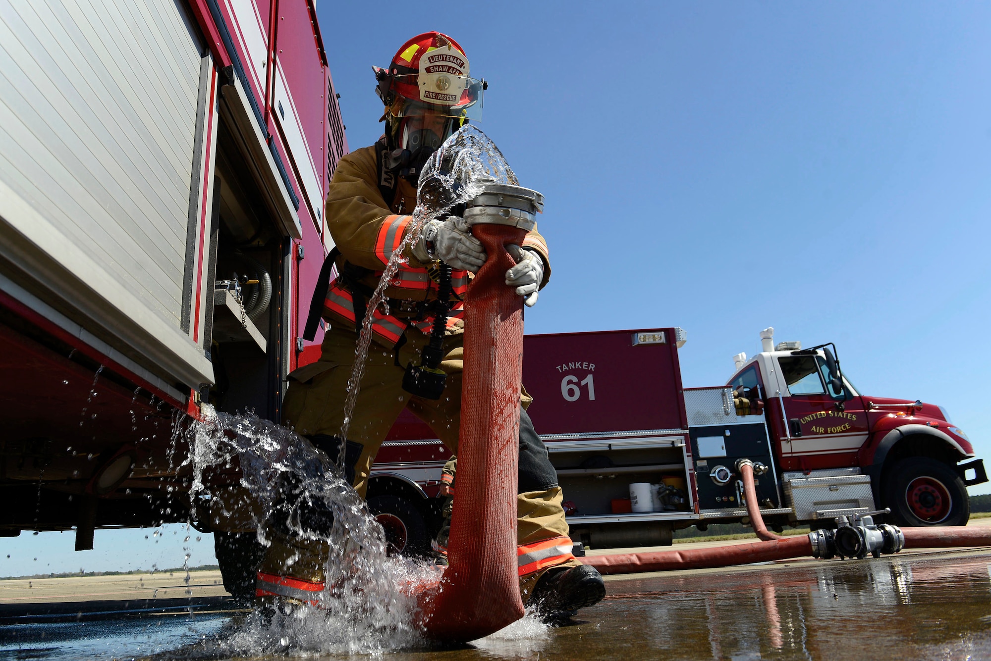 U.S. Air Force Staff Sgt. Larry Diaz, 20th Civil Engineer Squadron fire protection craftsman, removes a hose from a vehicle being supplied water from Tanker 61 during pilot ejection training at Shaw Air Force Base, S.C., March 15, 2016. Upon completion of training, hoses were disconnected and rolled back into their proper vehicles. (U.S. Air Force photo by Airman 1st Class Christopher Maldonado)