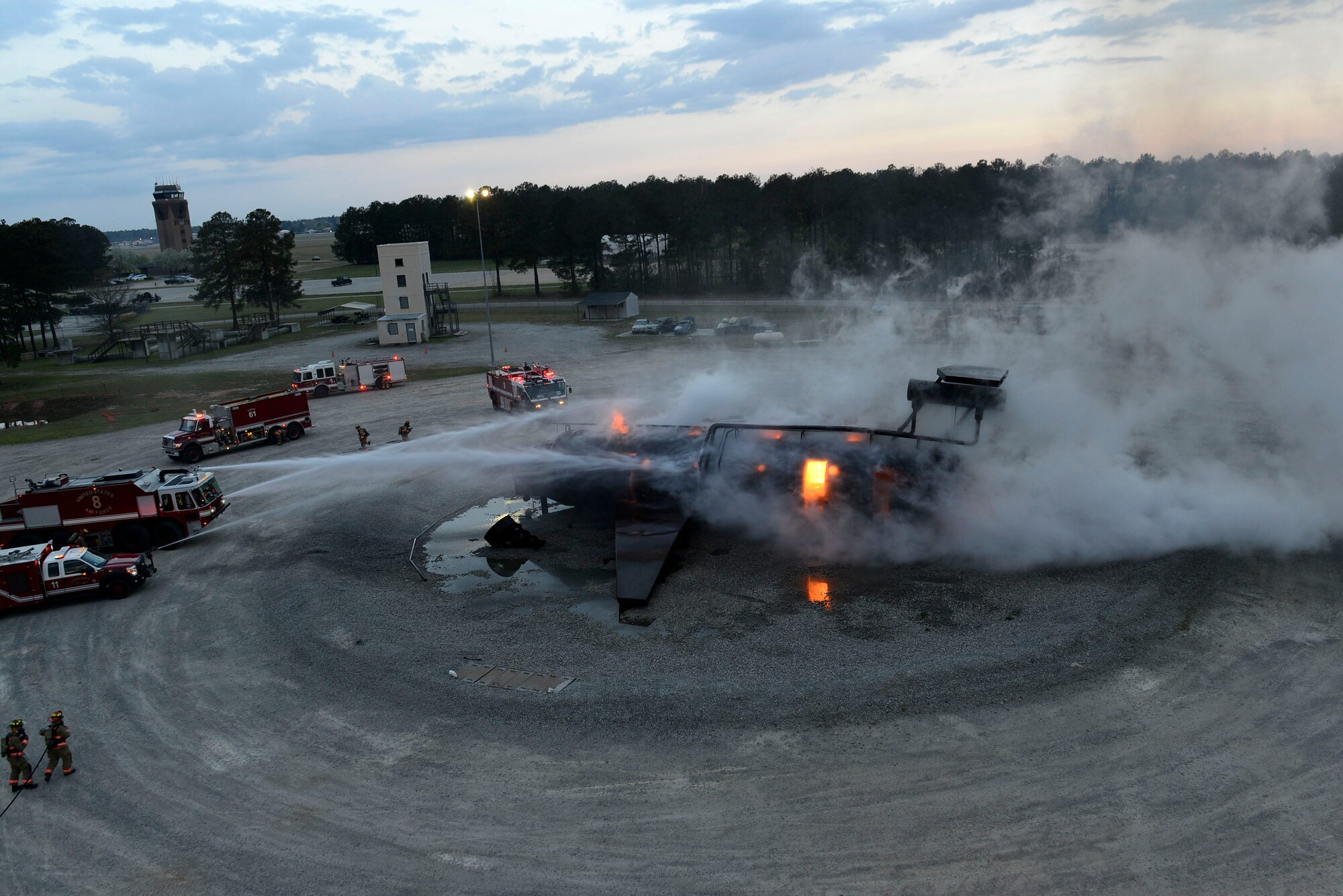U.S. Airmen assigned to the 20th Civil Engineer Squadron fire department extinguish an aircraft fire during training at Shaw Air Force Base, S.C., March 17, 2016. Firefighters assigned to the 20th CES fire department train on a mock C-130 to test their response time and efficiency in extinguishing an aircraft fire. (U.S. Air Force photo by Airman 1st Class Christopher Maldonado)