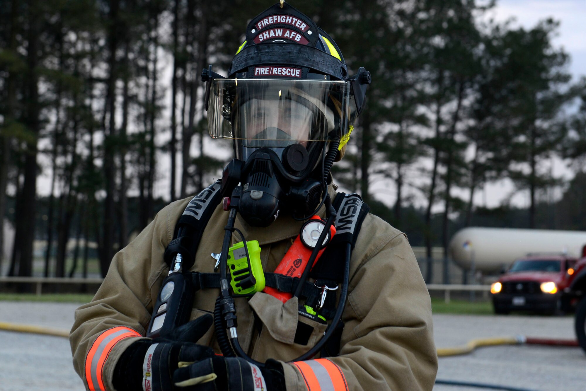 U.S. Air Force Senior Airman Nathan Webber, 20th Civil Engineer Squadron firefighter, waits for the conclusion of aircraft fire training at Shaw Air Force Base, S.C., March 17, 2016. Webber and other firefighters from the 20th CES fire department communicated and worked together to extinguish a fire on a mock C-130. (U.S. Air Force photo by Airman 1st Class Christopher Maldonado)