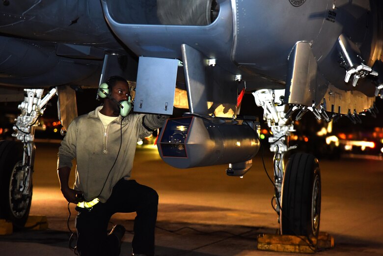 Senior Airman Brandon Farmer, 4th Aircraft Maintenance Squadron crew chief, performs pre-flight inspections on an F-15E Strike Eagle March 9, 2016, at Nellis Air Force Base, Nevada. Farmer and other 4th AMXS Airmen participated in Red Flag 16-2 to simulate deployed operations in a robust training environment. (U.S. Air Force photo/Staff Sgt. Chuck Broadway)
