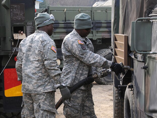 CAMP Humphreys, Republic of Korea (March 15) - Sgt. Shaun Green (right), a petroleum supply specialist from Company A, 602nd Aviation Support Battalion, 2nd Combat Aviation Brigade, 2nd Infantry Division, refuels a light medium tactical vehicle and other tactical equipment during an exercise at Camp Humphreys. 