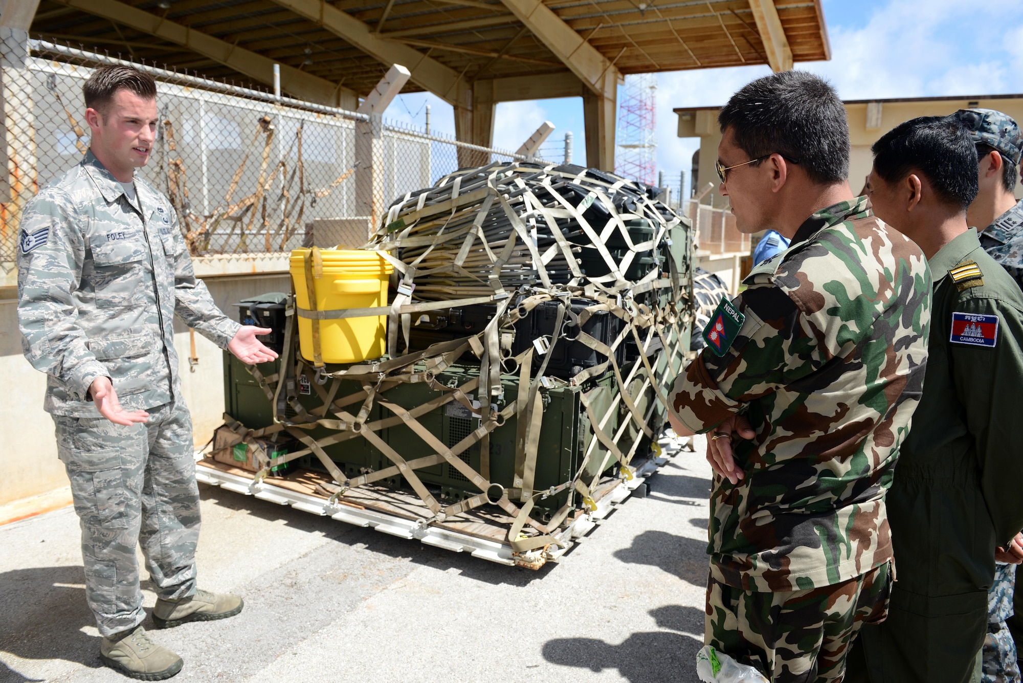 U.S. Air Force Staff Sgt. Joshua Foley, 36th Mobility Response Squadron aerial port supervisor, speaks with military logistics and maintenance experts from nine nations gather for a Pacific Agility 16-1 pallet build up-tour March 15, 2016, at Andersen Air Force Base, Guam. Pacific Agility is a Pacific Air Forces-led engagement focusing on a series of logistics subject-matter expert exchanges designed to increase partner capabilities, military relations and regional stability for the Indo-Asia-Pacific region. (U.S. Air Force photo by Airman 1st Class Arielle Vasquez/Released)