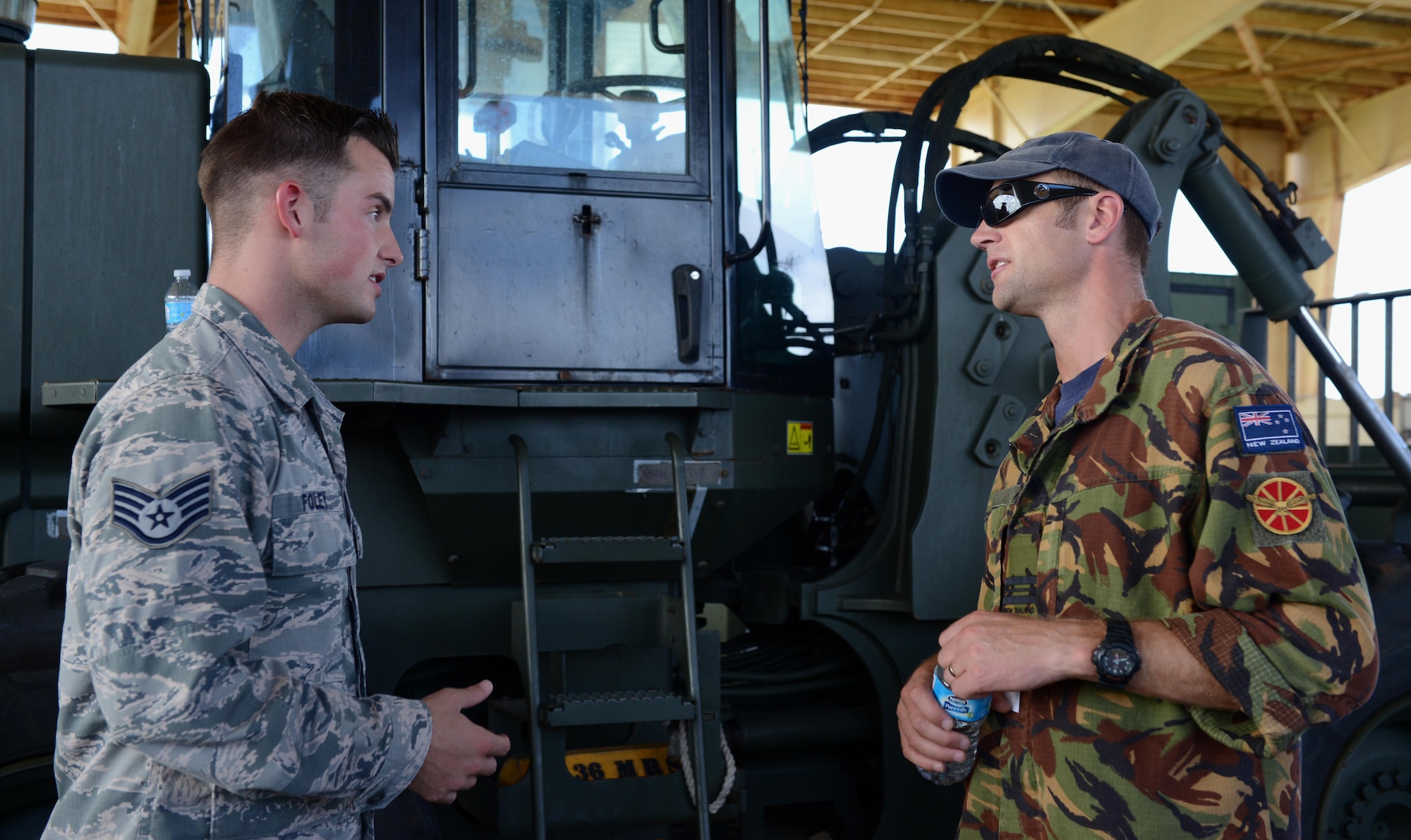 U.S. Air Force Staff Sgt. Joshua Foley, 36th Mobility Response Squadron aerial port supervisor, and Royal New Zealand Air Force Squadron Leader Brandon Purdue, operations squadron representative, discuss operational capabilities during Pacific Agility 16-1 March 15 , 2016, at Andersen Air Force Base, Guam. Pacific Agility is a Pacific Air Forces-led engagement focusing on a series of logistics subject-matter expert exchanges designed to increase partner capabilities, military relations and regional stability for the Indo-Asia-Pacific region. (U.S. Air Force photo by Airman 1st Class Arielle Vasquez/Released)