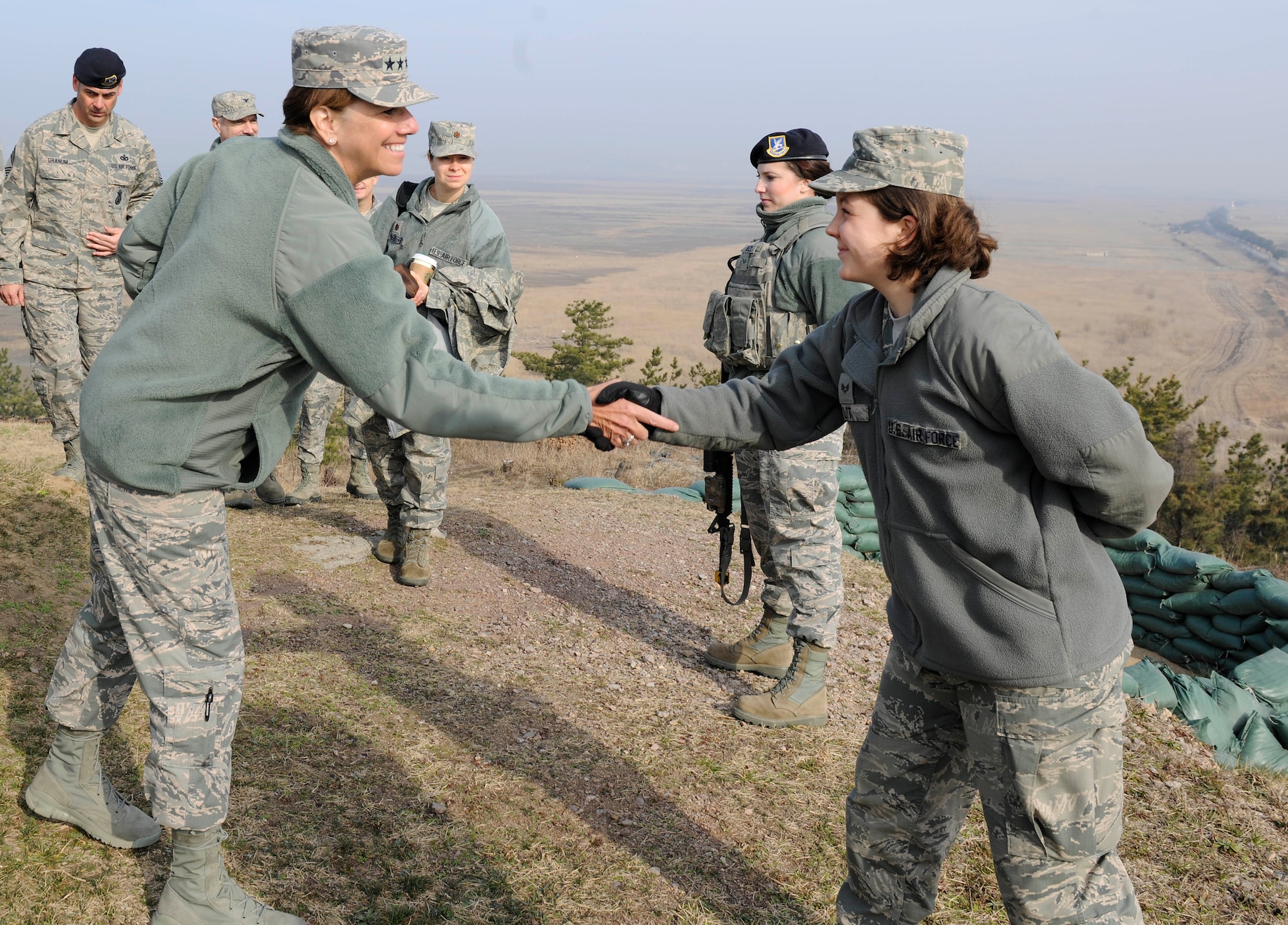 Gen. Lori J. Robinson, Pacific Air Forces commander, shakes hands with Senior Airman Kimberlee Kutt, 8th Force Support Squadron fitness center journeyman, during her visit to Kunsan Air Base, Republic of Korea, March 17, 2016. Robinson had the opportunity to see firsthand how Kunsan Airmen contribute to deterring aggression on the Korean Peninsula during her visit.