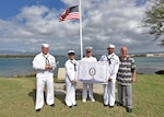 160311-N-QL961-165 PEARL HARBOR (Mar. 11, 2016) Sailors assigned to Joint Base Pearl Harbor-Hickam, and Jim Taylor, Navy Region Hawaii Pearl Harbor Survivor liaison, right, pose for a group photo with the USS Nevada (BB 36) Battleship Flag in front of the ship's memorial following its 100th anniversary of its commissioning ceremony. The ceremony was conducted at the Nevada memorial simultaneously as a similar ceremony was being held in Carson City, Nevada. (U.S. Navy photo by Mass Communication Specialist 1st Class Phillip Pavlovich/Released)