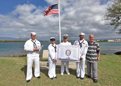 160311-N-QL961-165 PEARL HARBOR (Mar. 11, 2016) Sailors assigned to Joint Base Pearl Harbor-Hickam, and Jim Taylor, Navy Region Hawaii Pearl Harbor Survivor liaison, right, pose for a group photo with the USS Nevada (BB 36) Battleship Flag in front of the ship's memorial following its 100th anniversary of its commissioning ceremony. The ceremony was conducted at the Nevada memorial simultaneously as a similar ceremony was being held in Carson City, Nevada. (U.S. Navy photo by Mass Communication Specialist 1st Class Phillip Pavlovich/Released)